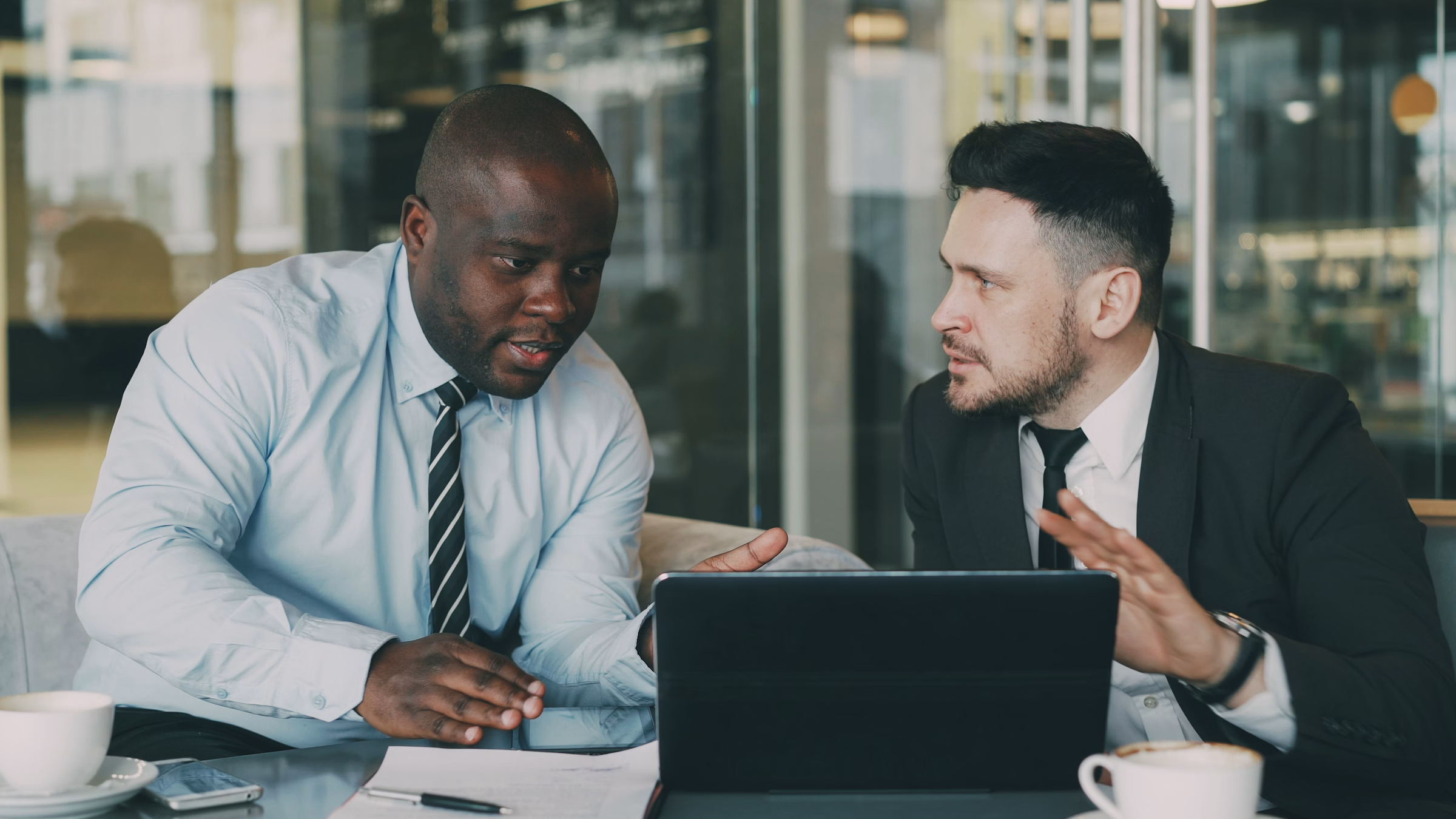 Business colleagues reviewing analytics and customer information together